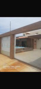 a large building with a garage door in front of it at Casa de Praia do Abais in Estância