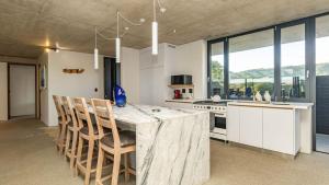 a kitchen with a large wooden table and chairs at Mi Amor Beach House in Sedgefield