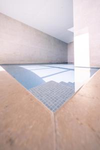 a room with a tile floor and a glass wall at Top uitzicht luxe appartement DUNES met terras POOL & GYM in Ostend