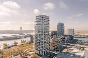 an aerial view of a tall building in a city at Top uitzicht luxe appartement DUNES met terras POOL & GYM in Ostend