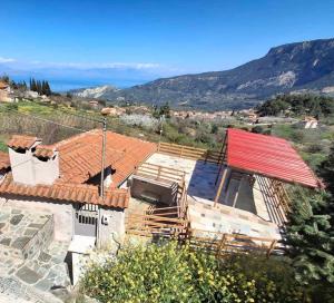 a house under construction with a red roof at Georgoulis Home in Ambelókipoi