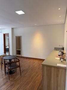 an empty room with a table and a counter top at Pousada Contos de Minas in Mariana