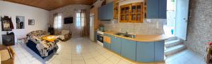 a kitchen with blue cabinets and a couch in a room at Georgoulis Home in Ambelókipoi