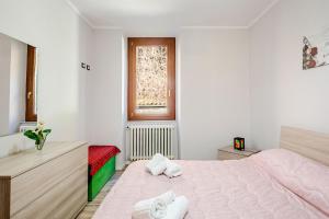 a white bedroom with a bed with towels on it at Nido della Rondine in Bagnoregio