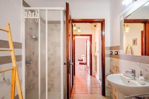 a bathroom with a sink and a shower at Nido della Rondine in Bagnoregio