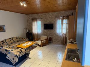 a living room with a couch and a table at Georgoulis Home in Ambelókipoi
