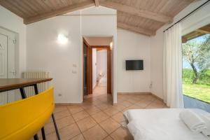 a bedroom with a bed and a television on a wall at Hotel Casa Piantoni in Limone sul Garda