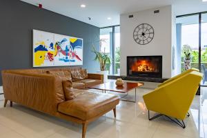 a living room with a couch and a fireplace at Hotel Palace Medjugorje in Međugorje