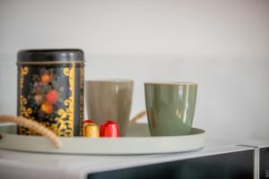 a table with two glasses and a can on it at Perle de Liévin in Liévin