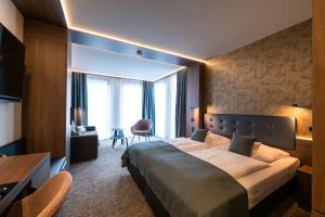 a hotel room with a large bed and a chair at Stadthotel Münster in Münster +77 photos