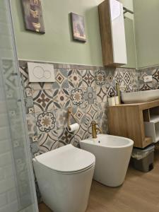 a bathroom with a toilet and a sink at RHouse in Rho