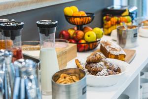 a table with bread and other foods on it at Hotel Palace Medjugorje in Međugorje