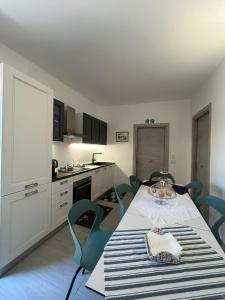 a kitchen with a table and blue chairs in a room at B&B Casaletto in San Nicola Arcella