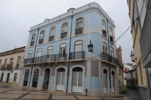 a blue and white building on a street at Legendary Bay - Suíte Temática in Seixal