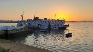 a ferry boat docked at a dock with a duck in the water at Legendary Bay - Suíte Temática in Seixal +25 photos
