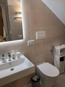 a bathroom with a sink and a toilet and a mirror at B&B Casaletto in San Nicola Arcella +20 photos