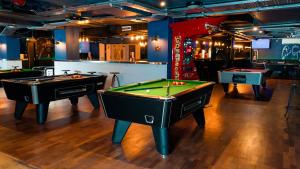 two pool tables in a room with billards at Temple Bar Hotel Dublin by The Unlimited Collection in Dublin