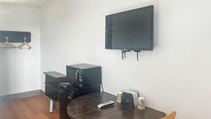 a room with a table and a tv on a wall at Motel 6 - Pecos, TX in Pecos +18 photos