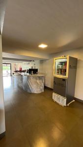 a kitchen with a refrigerator in the middle of a room at Cardoso Palace Hotel Rio Verde in Rio Verde