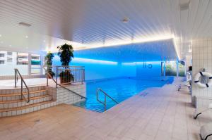 a large swimming pool in a building at Crowne Plaza Zürich by IHG in Zurich