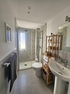 a bathroom with a shower and a toilet and a sink at El capricho in Fuengirola +9 photos