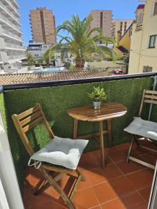 a table and chairs on a balcony with a table at El capricho in Fuengirola