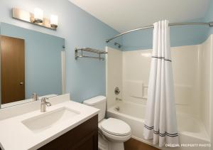 a bathroom with a sink and a toilet and a shower at Hotel Butler Inn in Butler