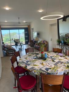 a dining room with a table and chairs at J'Vais Residence in Flic-en-Flac