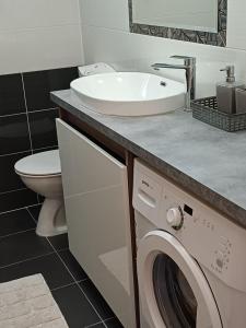 a bathroom with a sink and a washing machine at Apartments Jure Miljak in Podstrana +96 photos
