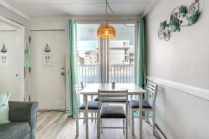 a dining room with a table and chairs and a window at Beachfront Wildwood Crest Condo w/ Pool Access! in Wildwood Crest