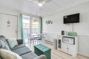 a living room with a couch and a tv at Beachfront Wildwood Crest Condo w/ Pool Access! in Wildwood Crest
