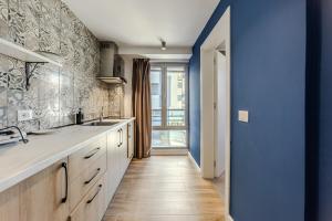 a kitchen with a sink and a blue wall at Love in Colours by PikHost in Durrës +291 photos