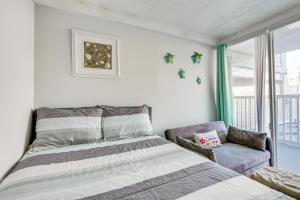 a bedroom with a bed and a couch and a window at Beachfront Wildwood Crest Condo w/ Pool Access! in Wildwood Crest +24 photos