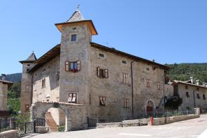 an old stone building with a tower at Locanda Alpina in Brez
