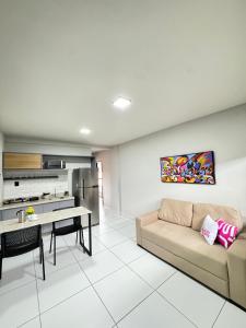a living room with a couch and a table at City Studios Apartamentos Novos em Natal in Natal