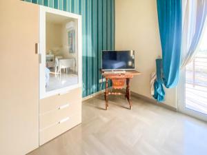 a bedroom with a desk with a computer on it at Blue Room - Camera Matrimoniale con Garage Privato in Bitonto