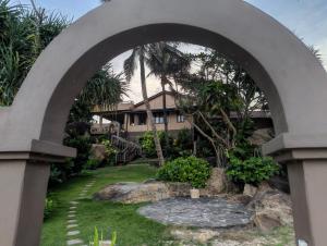 an archway in front of a house with a garden at Villa AyuSri in Ambalangoda