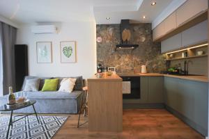 a kitchen and living room with a couch and a table at Mała Poleska - przytulny apartament z ogródkiem in Częstochowa