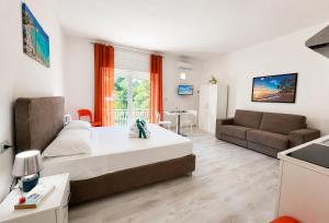 a bedroom with a bed and a living room at RestHouse The Village in Nardò