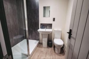 a bathroom with a toilet and a sink and a shower at The Royal Bar & Shaker in Morecambe
