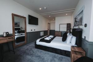 a hotel room with a bed and a mirror at The Royal Bar & Shaker in Morecambe
