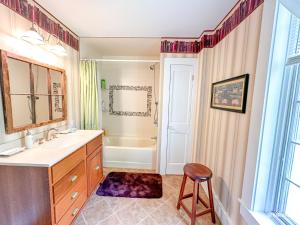 a bathroom with a sink and a bath tub at West Hill Farmhouse in Warren +44 photos