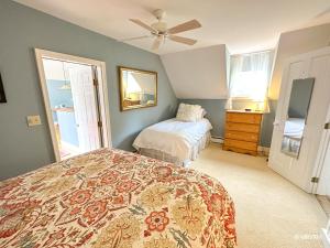 a bedroom with two beds and a ceiling fan at West Hill Farmhouse in Warren