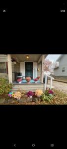 a front porch of a house with flowers on it at NH room rental in Akron