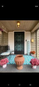 a front door of a house with a table and flowers at NH room rental in Akron +11 photos