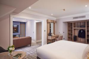 a bedroom with a bed and a living room at Bunratty Castle Hotel & Leisure Club, BW Premier Collection in Bunratty +118 photos