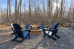 a group of chairs sitting around a fire pit at Firepit Game Room Seclusion and More in Locust Lakes Village