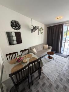 a living room with a table and chairs and a couch at D' Ehsan Homestay & Chalet in Kuala Terengganu