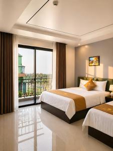 a bedroom with two beds and a large window at Sunrise Airport Hotel Noi Bai in Noi Bai +55 photos
