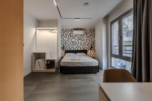 a bedroom with a bed and a wall at Love in Colours by PikHost in Durrës